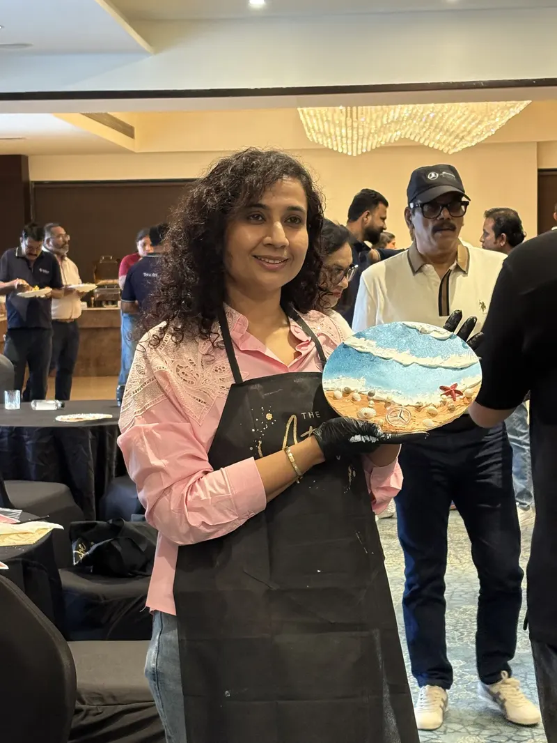 A participant holding her completed coastal texture piece
