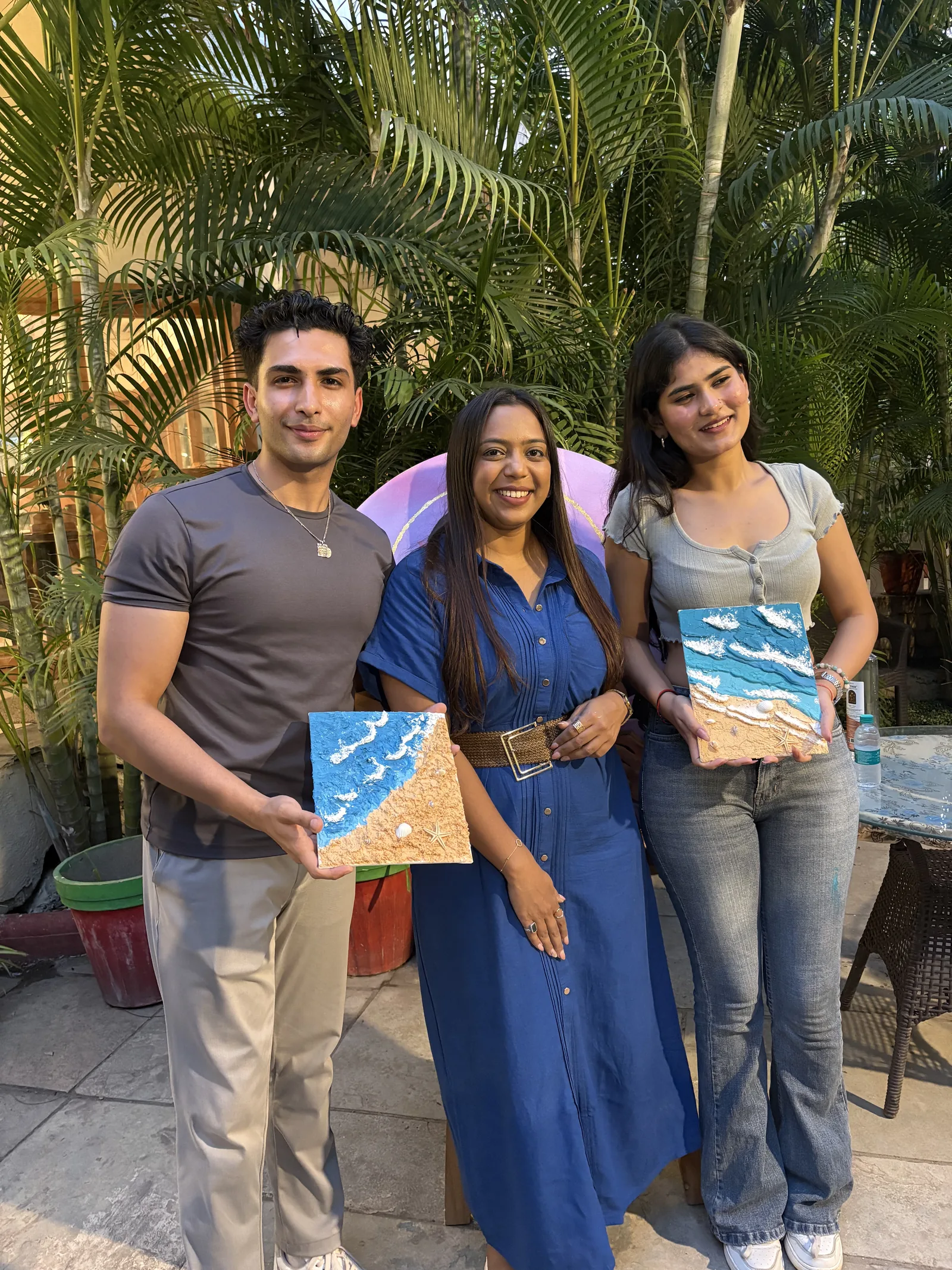 Three participants holding their beach canvases