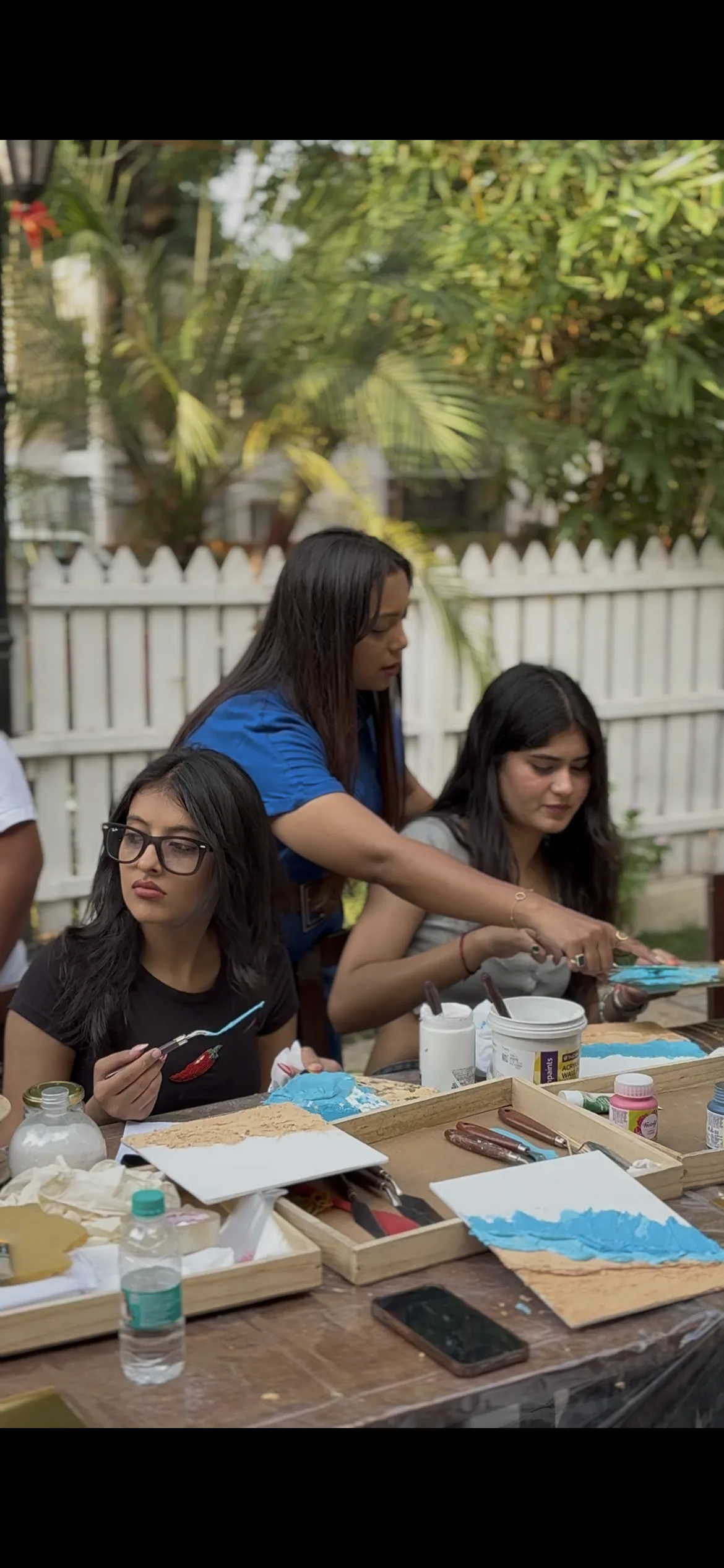 Jahnvi helping a young participant paint